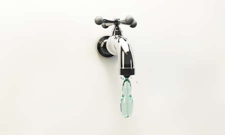 tap water drop falling down a metal tapの写真素材