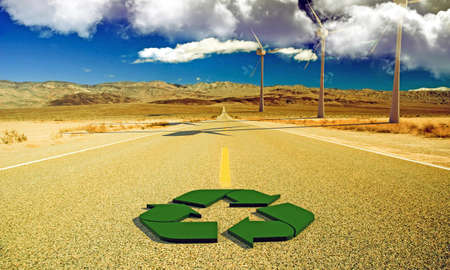 green recycle sign on a desert roadの写真素材