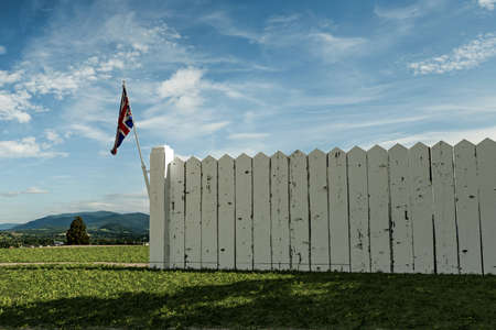 white wooden fence in a english gardenの写真素材