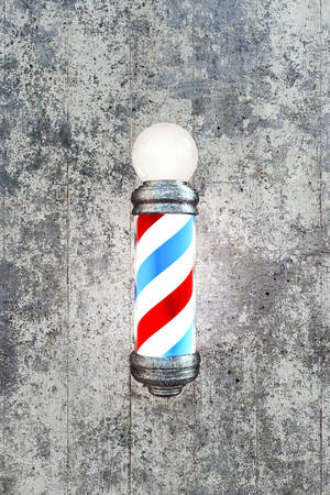 barber pole on concrete wallの写真素材