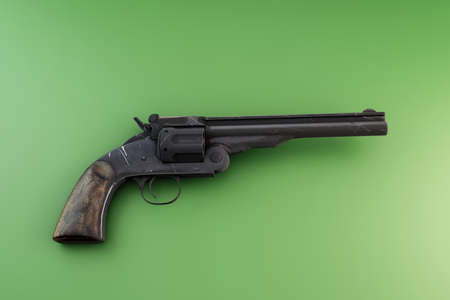 old revolver isolated on green background 3d illustration