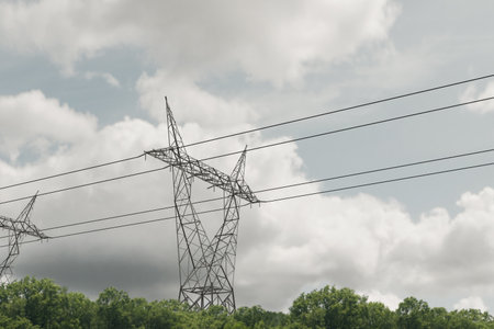 eltetric pylons below a cloudy sky 3d illustrationの写真素材
