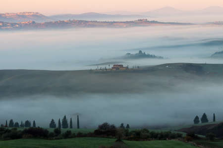 dawn with the presence of fogs Val d'Orcia Tuscanyの写真素材