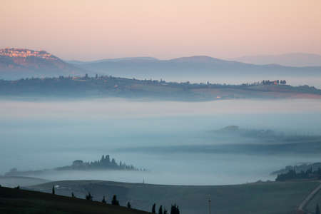 dawn with val d'orcia fogの写真素材