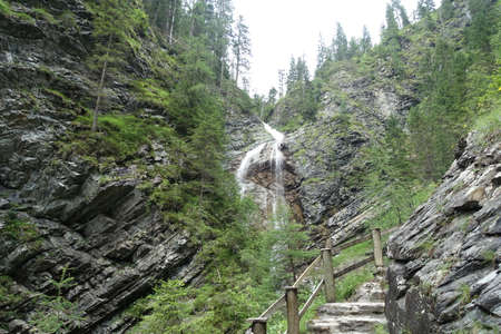 Sappada waterfalls loaded with alpsの写真素材
