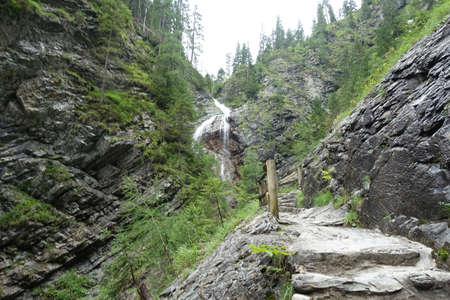 Sappada waterfalls loaded with alpsの写真素材