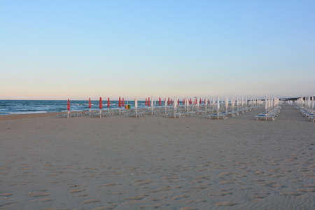 umbrellas closed in the evening with colored capsの写真素材