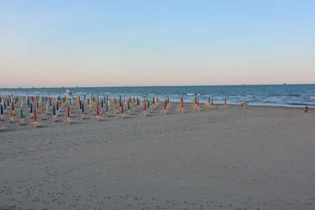 umbrellas closed in the evening with colored capsの写真素材
