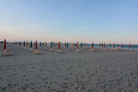 umbrellas closed in the evening with colored capsの写真素材