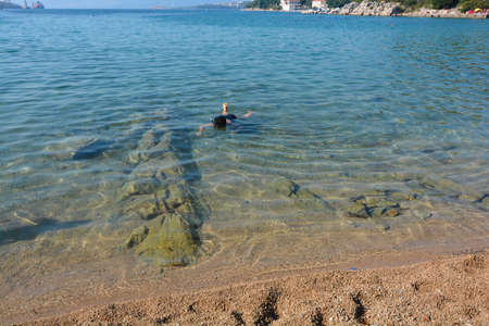 snorkeling in the clear waters of krkの写真素材