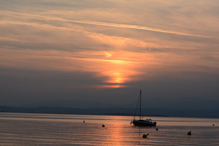 sunset with clouds on lake gardaの写真素材