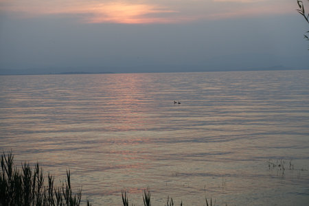 sunset with clouds lake gardaの写真素材