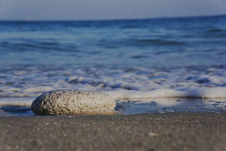 Larger stone lying individually on the beach, horizontalの写真素材