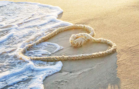 Dew heart-shaped on the beach, horizontalの写真素材