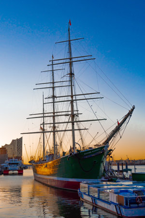 Hamburg, Germany, February 26, 2023: View from the northwest of a museum ship and the Elbphilharmonie in Hamburg during sunrise, horizontalのeditorial素材