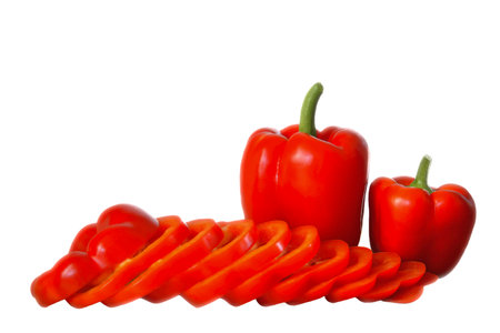 3 red peppers, one larger, one smaller and one sliced, lie in front of it, white background, horizontalの写真素材