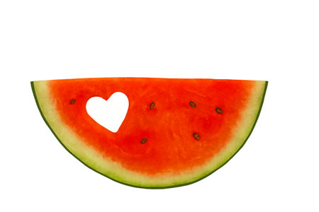 Piece of watermelon with a heart-shaped hole cut out, white background, horizontalの写真素材