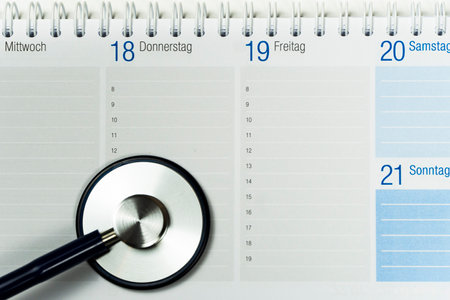 Partial view of a desk calendar showing a stethoscope, horizontalの写真素材
