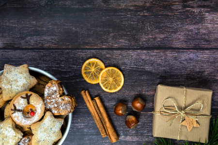 White porcelain bowl with Christmas cookies on dark wooden background, top view, horizontalの写真素材