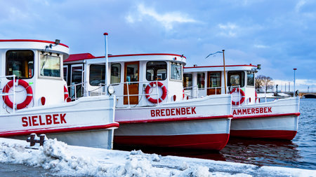 Hamburg, Germany, January 21, 2024: Partial view of three moored Alster steamers in winter, Sielbek, Bredenbek and Ammersbek, horizontalのeditorial素材