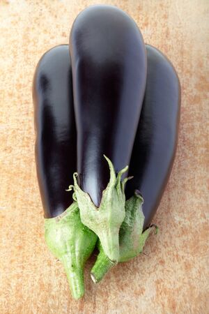 Aubergines on cutting boardの写真素材