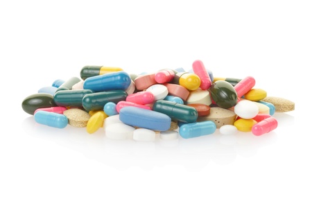 Pill and colorful medical capsule heap on white with clipping path