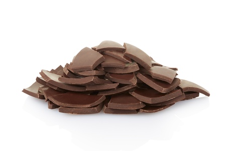 Chocolate pieces or chips heap on white with clipping pathの写真素材