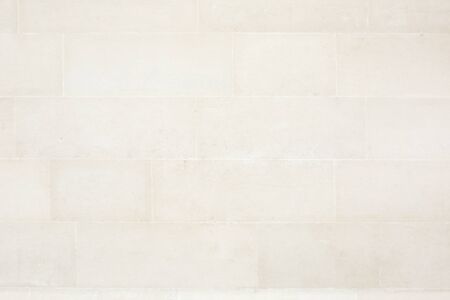 Beige tiled stone wall texture backgroundの写真素材