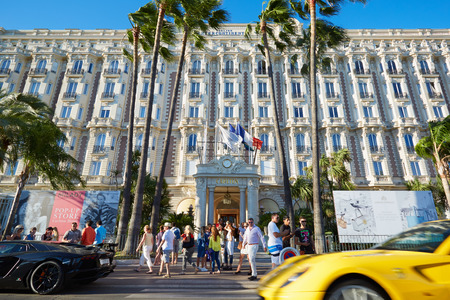 Cannes, people walking and luxury cars in front of hotel InterContinental Carltonのeditorial素材