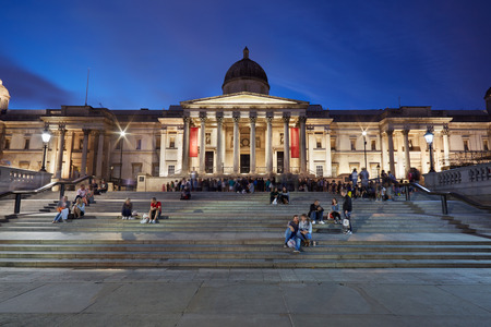 The National Gallery at Trafalgar Square in London in the evening,  people sitting on the stairwayのeditorial素材