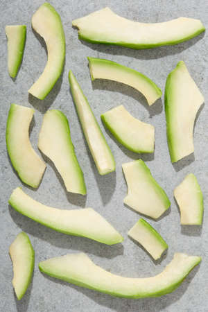 Avocado slices on stone background