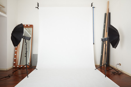 Photographic studio interior with white blank paper backgroundの写真素材