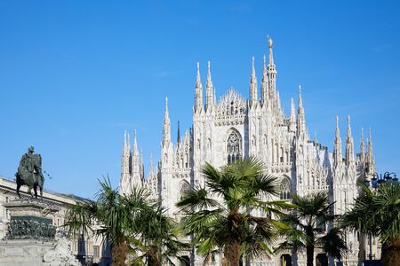 Milan Duomo cathedral with palm trees, blue sky in a sunny dayのeditorial素材