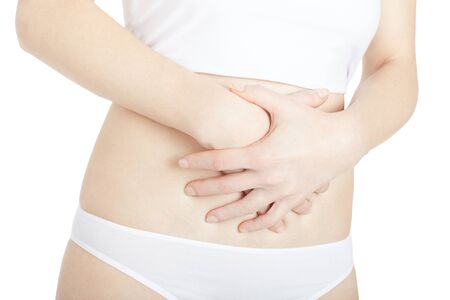 Woman with stomach pain isolated on white, clipping pathの写真素材
