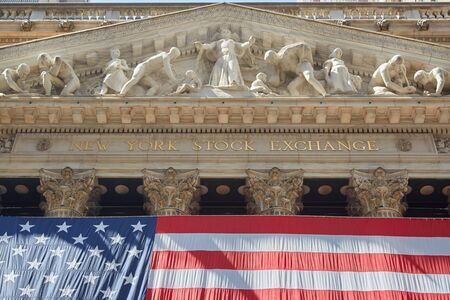 New York Stock Exchange golden sign and building with big US flag, financial district in New York in a sunny day on September 8, 2016 in New York. Also known as Big Board is the largest stock exchange in the world by capitalization.のeditorial素材