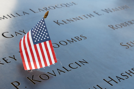National September 11 Memorial names with USA flag on September 8, 2016 in New York. The site commemorates the 2001 attacks which killed 2977 victims.のeditorial素材