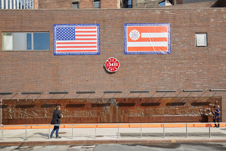 NEW YORK - SEPTEMBER 8: Fire Department Memorial wall with people in a sunny day on September 8, 2016 in New York. The sculpture is dedicated to the 343 firefighters that died on September 11.のeditorial素材