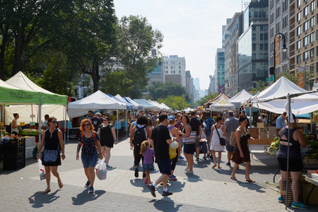 NEW YORK - SEPTEMBER 10: Union Square greenmarket with people in a sunny day on September 10, 2016 in New York. The market is held four days each week.のeditorial素材