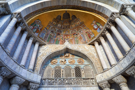 Venice, San Marco basilica facade details with golden, colorful mosaics and marble columns in Italyの写真素材