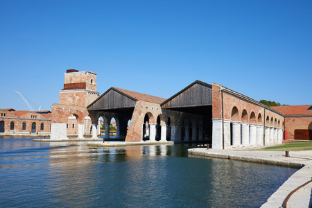 Venetian Arsenal with docks, canal and arcade, blue sky in summer in Venice, Italyのeditorial素材