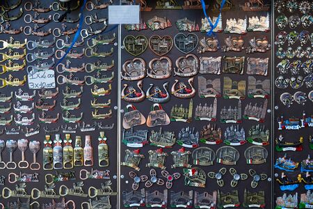 VENICE, ITALY - AUGUST 15, 2017: Venice, magnet souvenirs background in shape of gondola, Saint Mark basilica, masks in a street shop in Italyのeditorial素材