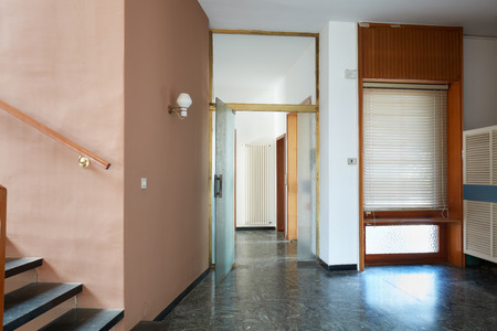 Entrance with black marble floor and glass door in apartment interior in old houseの写真素材