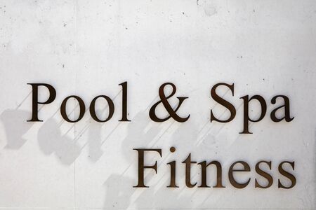 SANKT MORITZ, SWITZERLAND - AUGUST 16, 2018: Pool, spa and fitness writing in metal letters on...