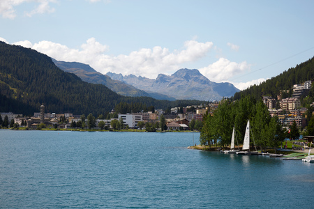 Sankt Moritz town and lake with sail boats in a sunny summer day in Switzerlandのeditorial素材