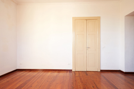 Empty room with wooden floor and door in old houseの写真素材