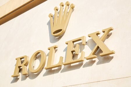 MONTE CARLO, MONACO - AUGUST 19, 2016: Rolex luxury watch store golden sign in sunlight in Monte...