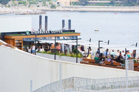 MONTE CARLO, MONACO - AUGUST 19, 2016: Starbucks Coffee cafe terrace with people in summer in Monte Carlo, Monaco.のeditorial素材