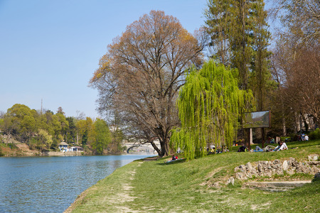 TURIN, ITALY - MARCH 31, 2019: Po river bank path with trees and people in a sunny day, blue sky in Piedmont, Turin, Italy.のeditorial素材