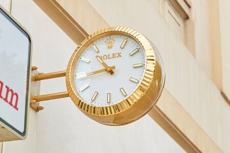 MONTE CARLO, MONACO - AUGUST 20, 2016: Rolex golden clock close to jewelry sign, luxury store in Monte Carlo, Monaco.のeditorial素材