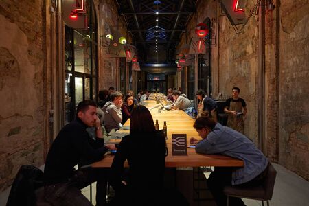 TURIN, ITALY - NOVEMBER 3, 2018: Ogr, Officine Grandi Riparazioni cafe interior with people, evening in Turin, Italy.のeditorial素材